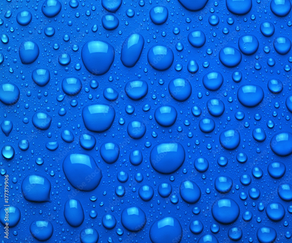 Droplets of liquid on blue surface