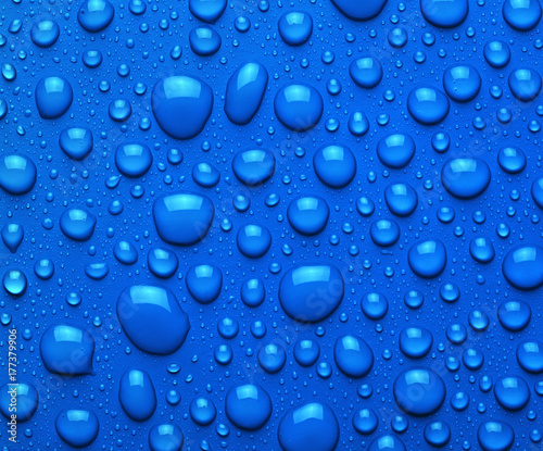 Droplets of liquid on blue surface