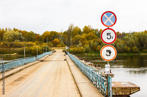 Ponton bridge with traffic signs over the Klyazma River. Gorokhovets, Vladimir oblast, Russia photo