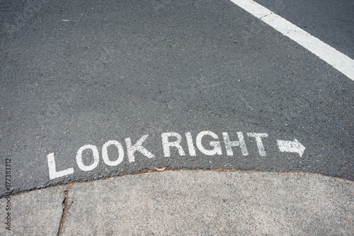 sign on road in Sydney reminding pedestrains to look right for oncoming traffic photo