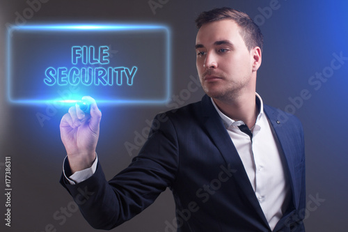 The concept of business, technology, the Internet and the network. Young businessman showing inscription: File security