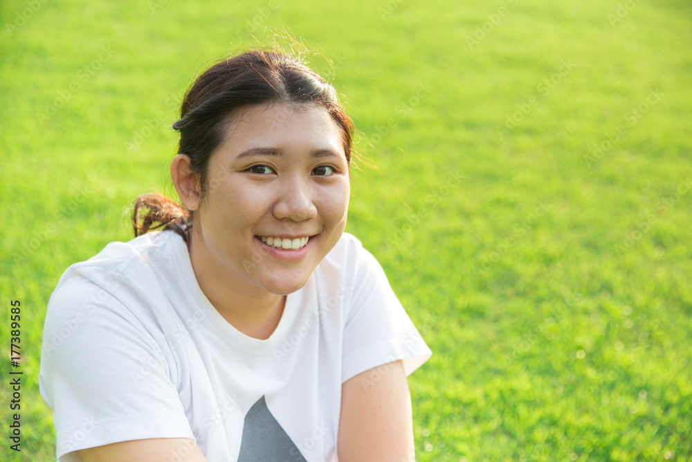 cute asian teen smile with good healthy teeth on green grass background cute asian teen smile with good healthy teeth on green grass background