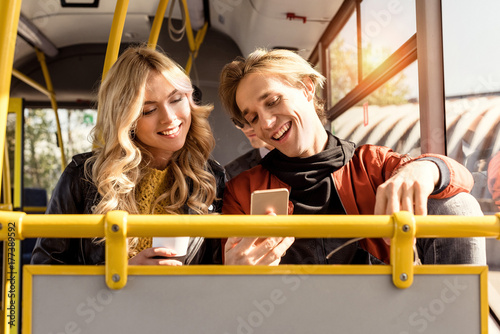 couple with smartphone in public transport