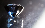 A blue gem on a black background