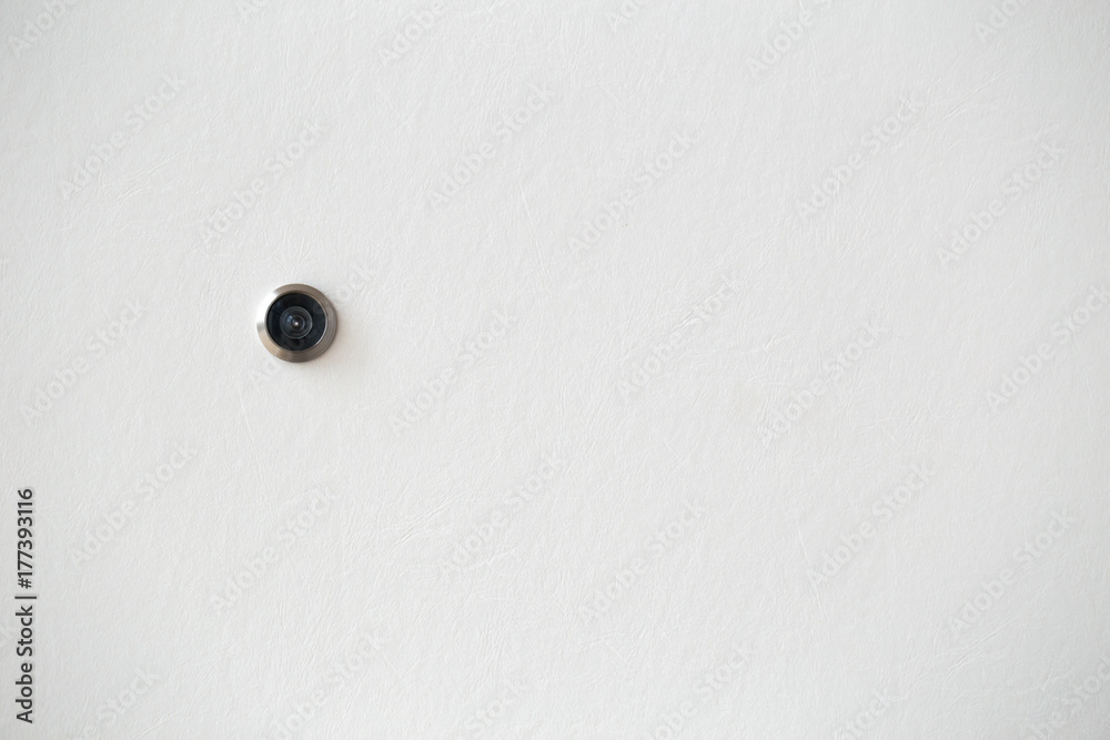 door hole or peephole on white wooden door with space for text door hole or peephole on white wooden door with space for text