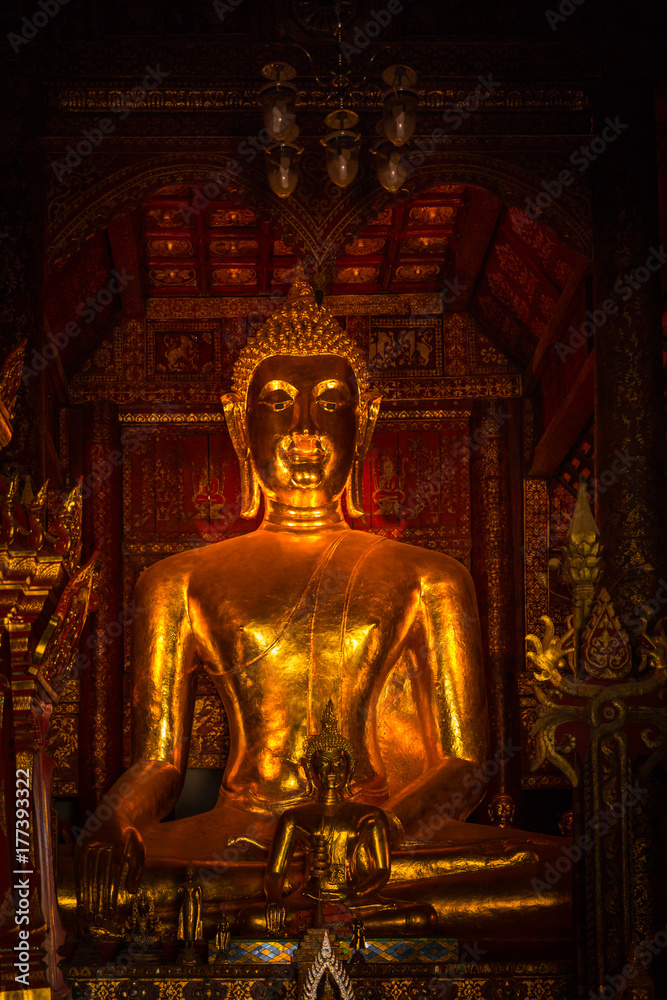 Thai golden buddha art full old antique grow in the dark vertical shot Thai golden buddha art full old antique grow in the dark vertical shot