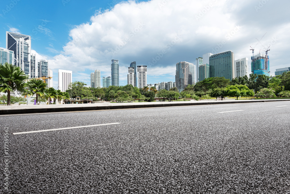 empty asphalt road and modern buildings in midtown of modern city