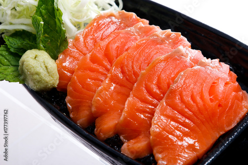 Close up Japanese sashimi salmon decoration with wasabi and vegetable 