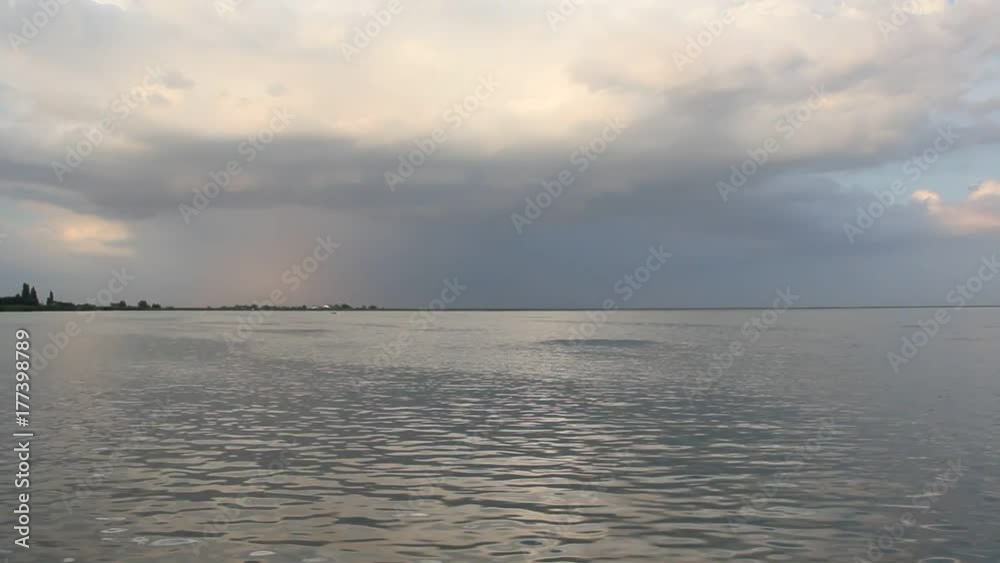 The lake in the setting sun before the impending storm. The lake in the setting sun before the impending storm.