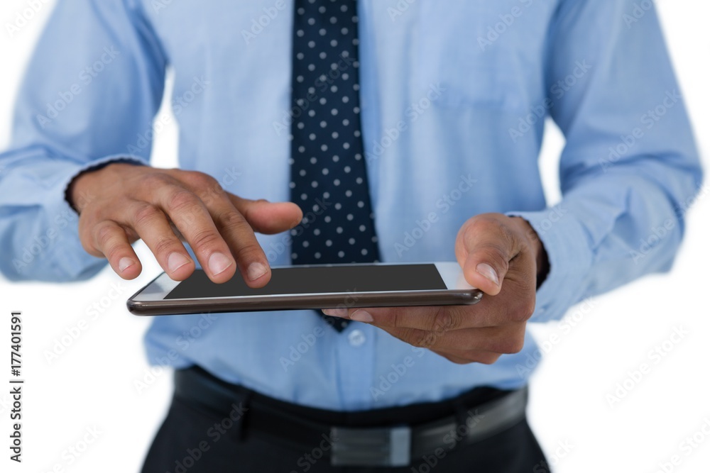 Mid section of businessman touching tablet computer Mid section of businessman touching tablet computer