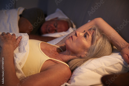 Worried Senior Woman In Bed At Night Suffering With Insomnia