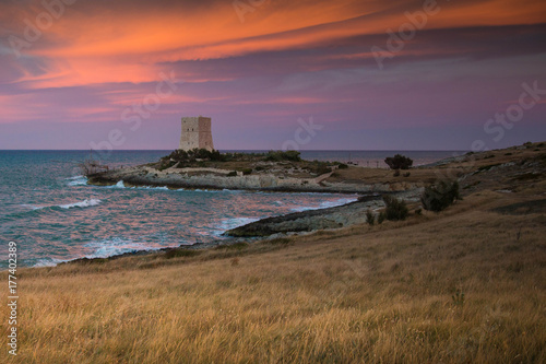 Dramatic sunset on the Molinella beach near Vieste  Italy  with old defense tower.