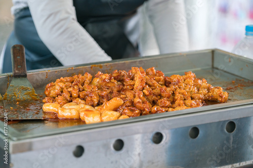 Rice cake korean  food that Topokki on bowl hold by hand Street food in South Korea photo