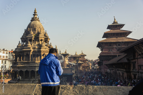 unknown guy looking at the crowd of people at Patan Durbar Square Nepal photo