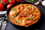 Chicken breast with tomato sauce in frying pan