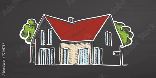 Small colored house on chalkboard