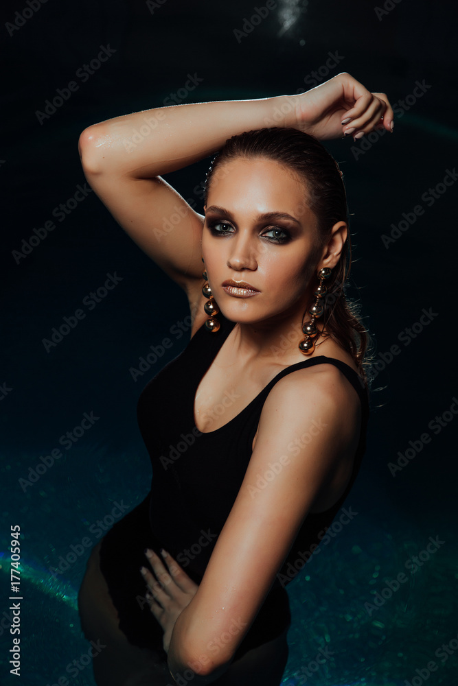 Fashion Sexy portrait of a girl in the pool. Woman's Black swimsuit, turquoise water in the spa. Fashion Sexy portrait of a girl in the pool. Woman's Black swimsuit, turquoise water in the spa.