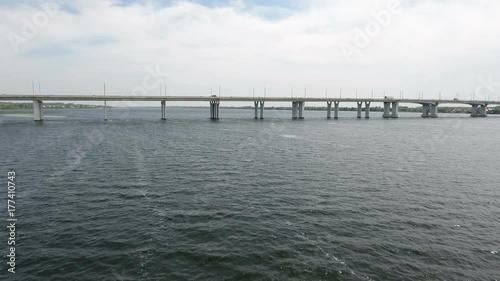Wallpaper Mural  An impressive bird`s eye view of an extra long modern bridge over the Dnipro with a lot of moving cars and trucks on a sunny day in summer. The sky is covered with fine fluffy clouds Torontodigital.ca