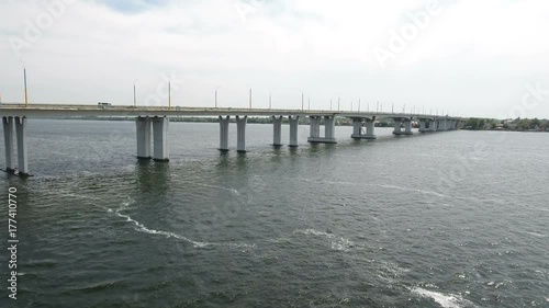 Wallpaper Mural A fabulous aerial view of a long modern bridge over the Dnipro with a lot of moving cars and trucks on a sunny day in summer. The skyscape is covered with fluffy white clouds. It looks great Torontodigital.ca