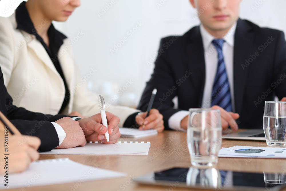Group of business people or lawyers at meeting, hands close-up Group of business people or lawyers at meeting, hands close-up