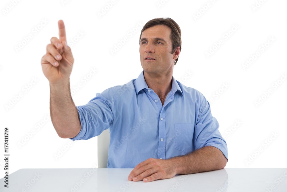 Male executive pressing an invisible virtual screen Male executive pressing an invisible virtual screen