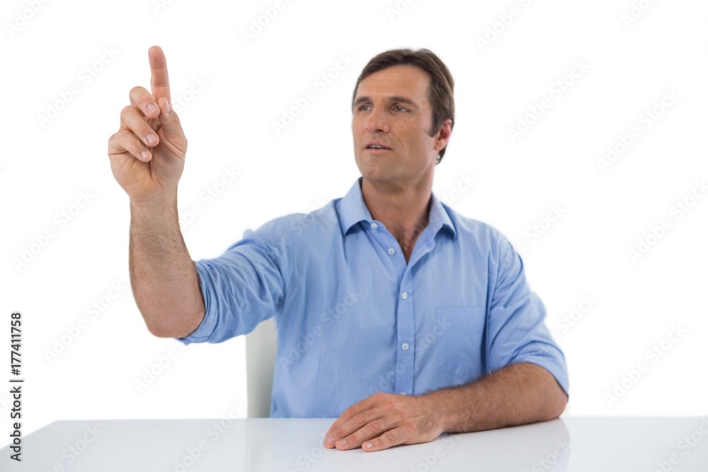 Male executive pressing an invisible virtual screen Male executive pressing an invisible virtual screen