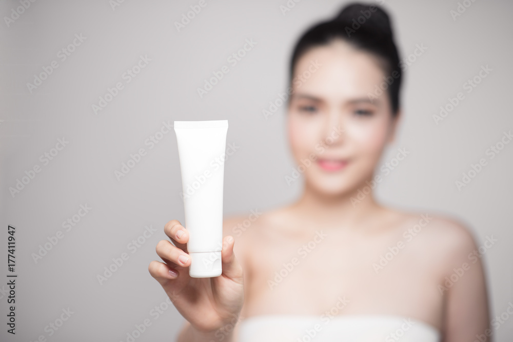 Beauty concept. Asian pretty woman with perfect skin holding cosmetic bottle Beauty concept. Asian pretty woman with perfect skin holding cosmetic bottle