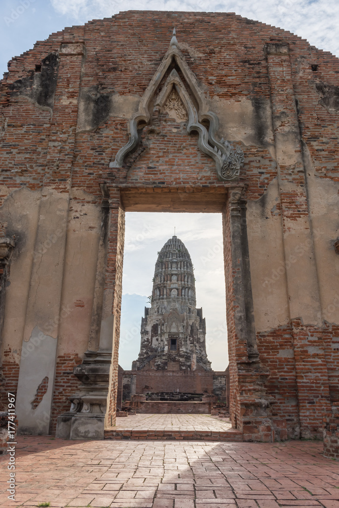 Ancient wall with pagoda in the background at Wat Ratchaburana Temple Ayutthaya