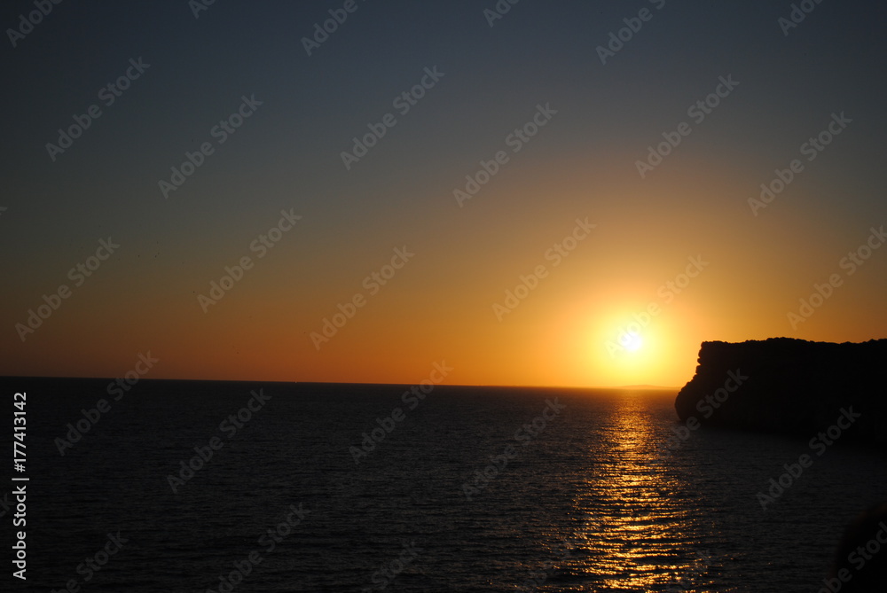 Beautiful sunset at Cova d'en Xoroi caves on island of Menorca.