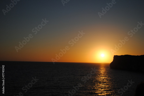 Beautiful sunset at Cova d'en Xoroi caves on island of Menorca.