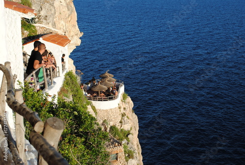 Cova d'en Xoroi disco in sea shore cliffs.