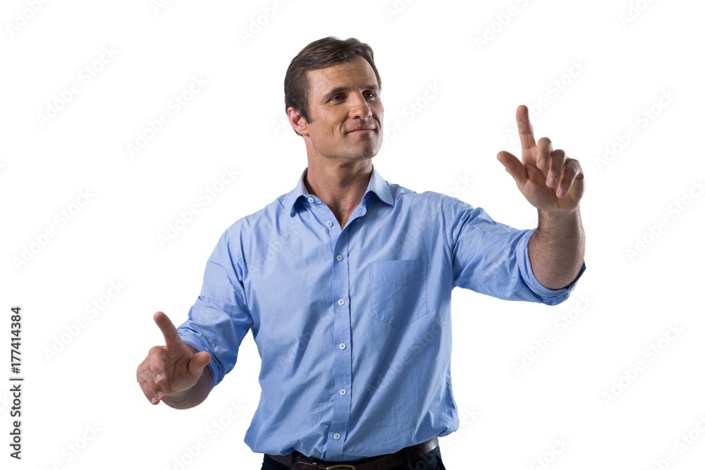 Male executive pressing an invisible virtual screen Male executive pressing an invisible virtual screen