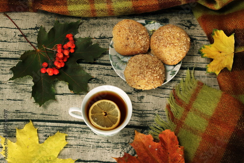 Tea with lemon, autumn leaves and cookies