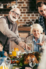 family cutting thanksgiving turkey