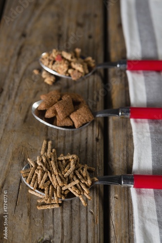 Three spoons with various breakfast cereals photo