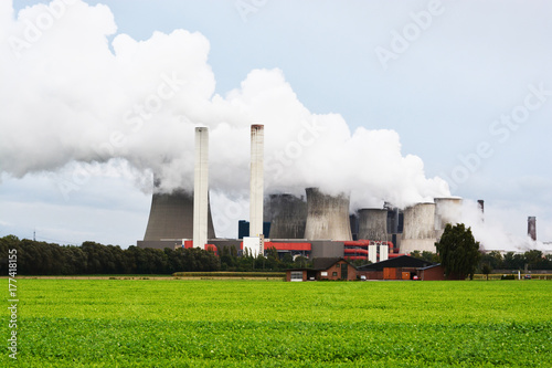 Environmental problems concept with fumes or steam rising from power plant smokestacks 