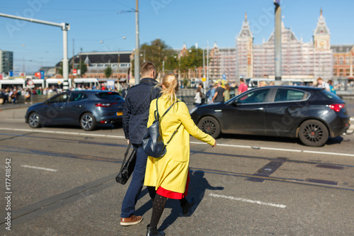Young couple is crossing the road in wrong place, Amsterdam