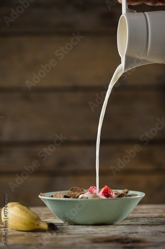 Milk being poured in wheat flakes
