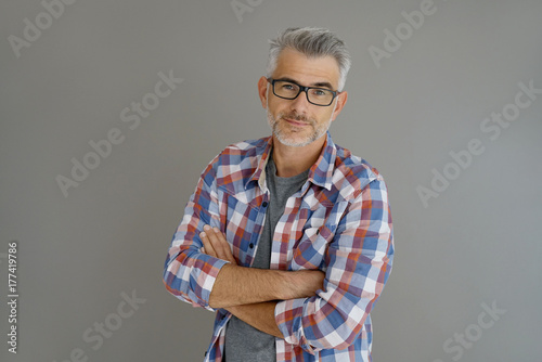 Принти на полотні Casual man with grey hair standing on background, isolated