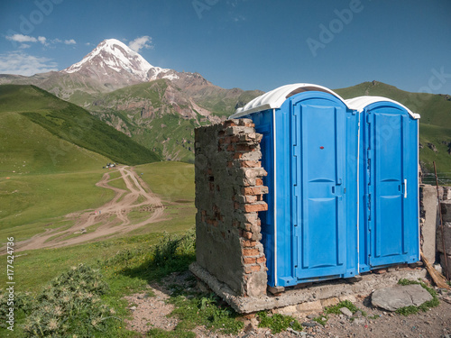 Removable toilet in pristine nature under snowy mountain