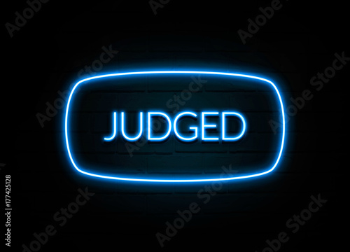 Judged - colorful Neon Sign on brickwall