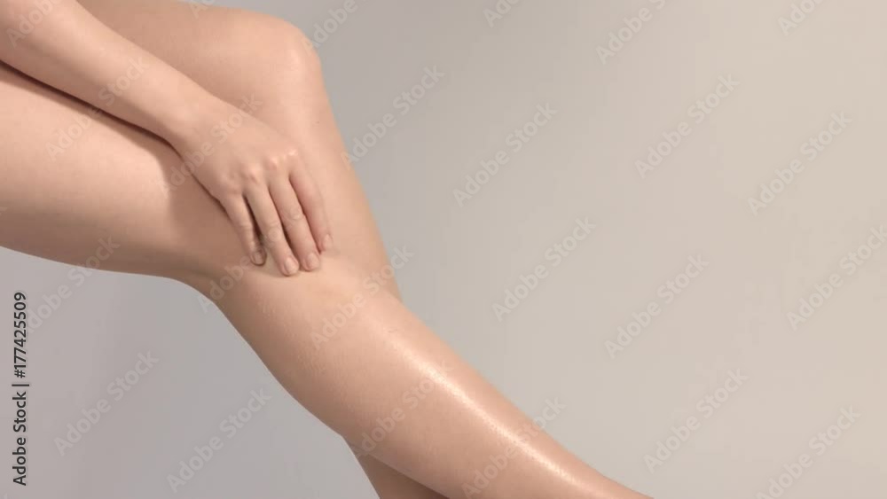 Beautiful female legs overgrey background.