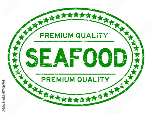 Grunge green premium quality seafood oval rubber seal stamp on white background