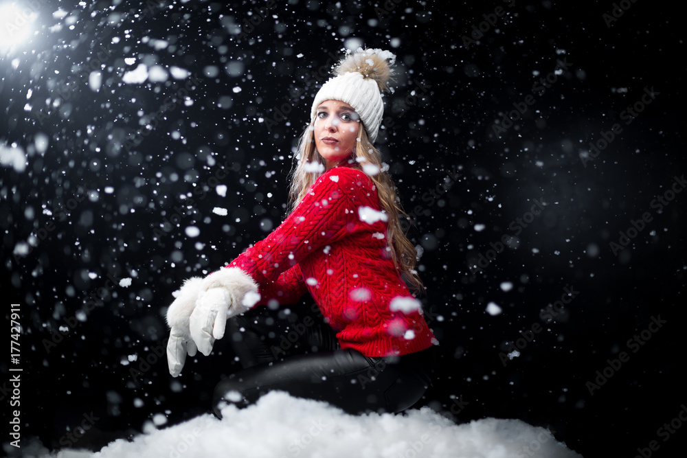 Girl in red jumper posing in snow