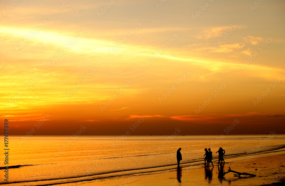 Fototapeta premium group of people play sea water is a silhouette