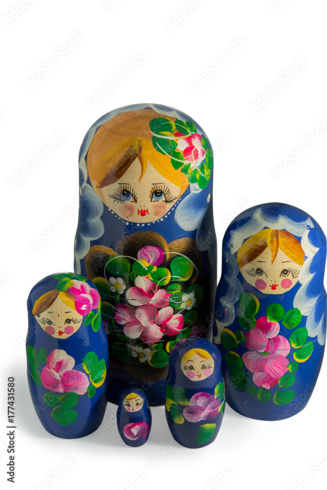 Matryoshka doll game closeup on isolated white background. Matryoshka doll is a Russian traditional game, one babushka include others, children disassembly all the babushkas. 
