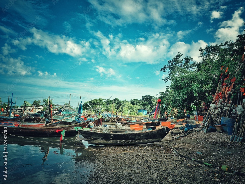 Fishing boats in the harbour with blue sky. Beautiful landscape and seascape of the traditional fisherman and nature.