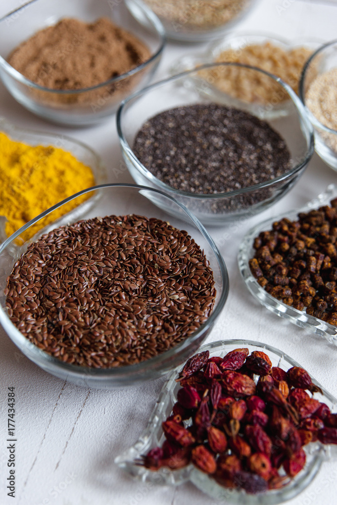 Superfoods in glassware on white background. Bright colorful still life of healthy food products.