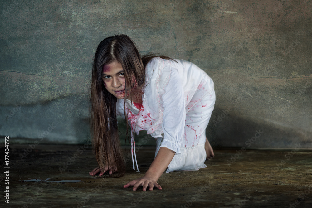 Zombie woman crawling on the floor with bloody Photos | Adobe Stock