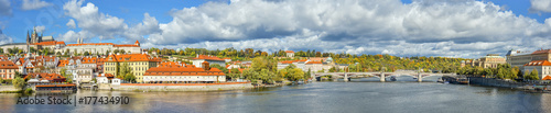 Prague, Czech Republic - October 12, 2017: Beautiful autumn panorama of river Vltava, ancient Jirásek bridge, old city center and Saint Vitus Cathedral, Prague, Czech Republic photo